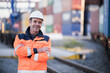 © Westend61 - Happy male blue-collar worker with arms crossed in dock