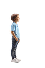 Poster - Full length profile shot of a boy in a blue t-shirt standing and watching something