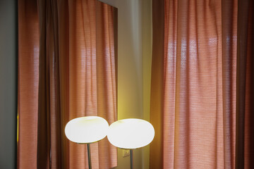 Poster - Stylish and moody image of a room corner with table lamp and velvet curtains