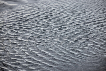 Poster - Closeup shot of textural details on gray sand