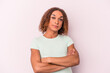 © Asier - Young latin transsexual woman isolated on pink background who feels confident, crossing arms with determination.