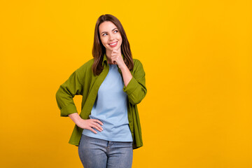 Sticker - Photo of sweet charming young lady wear green shirt arm chin looking empty space smiling isolated yellow color background