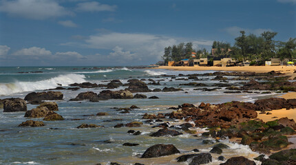 Wall Mural - West Africa. Senegal. Rocky-sandy beach of the resort town of Ngaparou on the Atlantic Ocean.