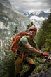 © lightpoet - Young, male climber on a via ferrata route - climbing on a rock in Swiss Alps