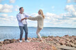 Energetic and happy man and woman near sea
