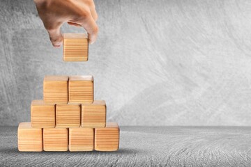 Wall Mural - Hand putting and stacking blank wooden cubes on the desk