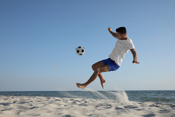 Sticker - Man kicking football ball on beach near sea