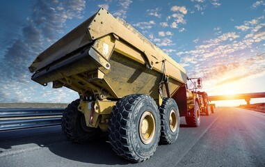 Large quarry dump truck. Big mining truck at work site. Loading coal into body truck.