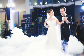 First wedding dance of newlywed couple in restaurant