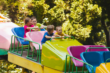 Wall Mural - The confused kids ride a roller coasters for the first time