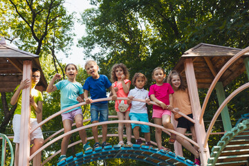 Wall Mural - The group of friends spend time together in the playground