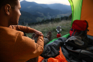 Poster - Man inside of camping tent in mountains