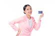 Portrait of a happy young asian woman wearing pink suit holding bank card, credit card isolated on white background. Business online shopping concept.