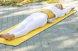 © nuzza11 - The woman put the roller under her back. Prevention of back pain. High quality photo