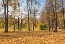 Old Gazebo-rotunda In An Autumn Park With Fallen Leaves
