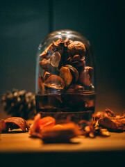 Wall Mural - Vertical shot of a jar filled with walnut peels