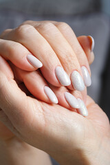 Wall Mural - Female hands with new manicure. Shallow depth of field