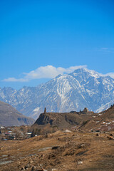 Wall Mural - In a mountain valley, a breathtaking landscape of giant covered mountains in the background