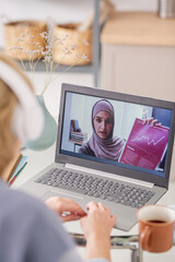 Aufkleber - Young Muslim female on lapto poscreen showing financial document and explaining graph during online course of study