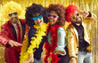 © Studio Romantic - Bunch of excited young friends having fun together. Diverse group of happy people in boas, cool sunglasses and funny silly curly wigs dancing at crazy pop music nightclub disco party