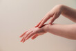 © oksix - Female hands and nourishing oil on the beige