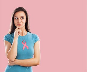 Wall Mural - Happy woman with a pink satin ribbon. World Cancer Awareness Day.