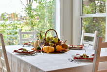 Fall Harvest Table Centerpiece Of Pumpkins, Squash And Apples For Thanksgiving Table Setting 