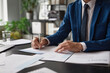 Cropped portrait of unrecognizable successful businessman signing contract at desk in office, copy space