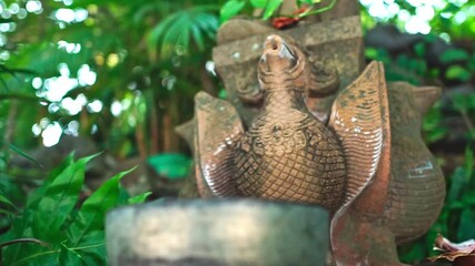 Poster - A sculpture of Buddha on top of the fountain in a park