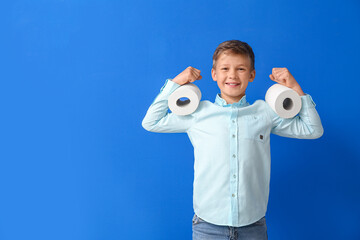 Wall Mural - Funny little boy with rolls of toilet paper on blue background