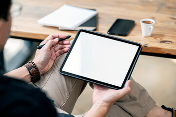 Fototapete - man hand using portable tablet at cafe room.