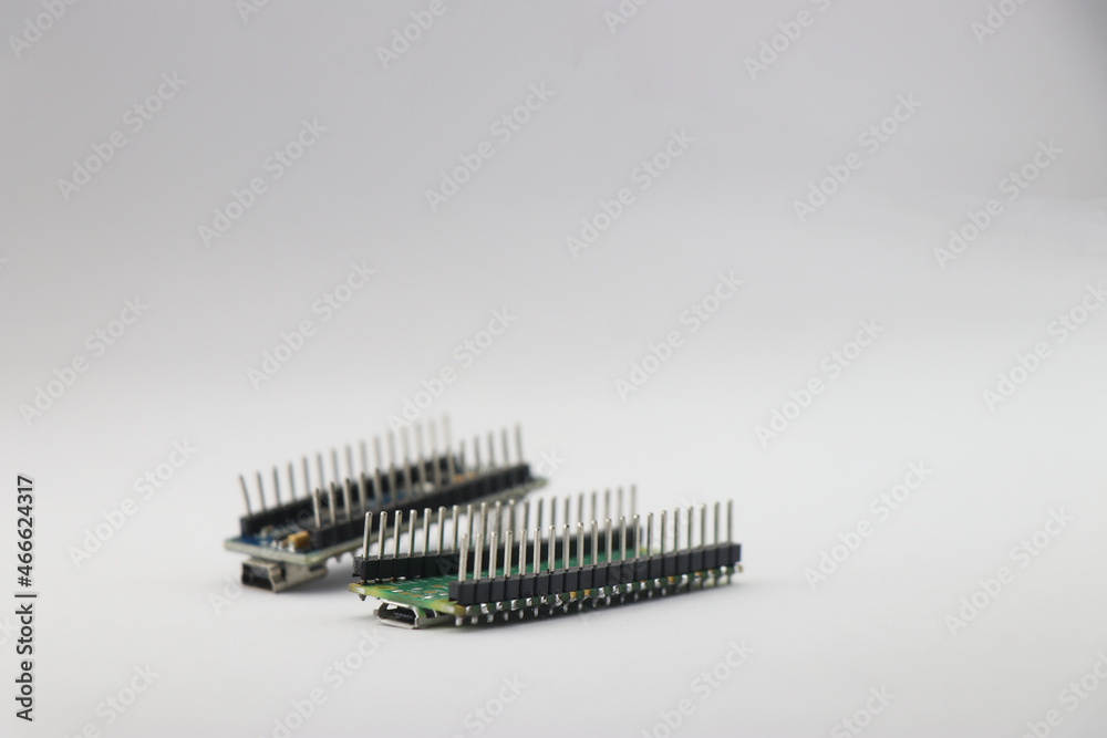 Pins of microcontroller board isolated on white, Header pins of circuit board side view
