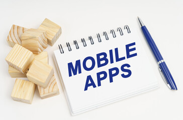 Poster - On the table are cubes, a pen and a notebook with the inscription - Mobile Apps