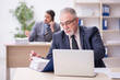© Elnur - Two male employees working in the office