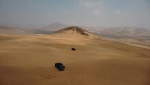 AERIAL - Off-road 4x4 Trucks In Ica Desert Sand Dunes, Peru, Forward Pan Right
