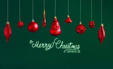 Poster - Merry Christmas and happy new year text with red bauble hanging decoration hanging on dark modern green background.winter holiday greeting card