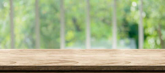 Fototapete - wooden table background with blur window see through garden at home.Mockup banner space for product display for advetising at online media