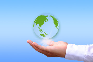 Poster - Save energy to help the environment, with a hand holding the earth on a blue background.