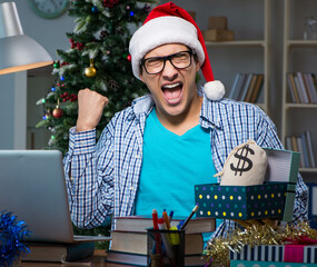 Wall Mural - Young man working at home on christmas day