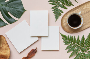 Wall Mural - Styled summer wedding mockup. Blank greeting and invitation card. Green tropical leaves with invitation card on table.