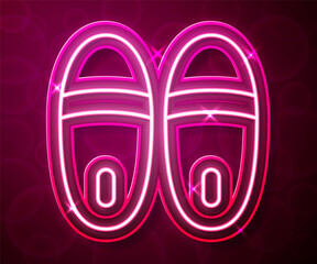 Wall Mural - Glowing neon line Slippers icon isolated on red background. Flip flops sign. Vector