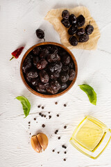 Wall Mural - Black olives in bowl. Sun-dried black olives. Top view.