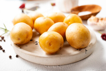 Wall Mural - Peeled potatoes for cooking, raw potato on a table