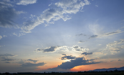 Wall Mural - Colorful sunset and sunrise with clouds.Blue and orange color of nature.Many white clouds in the blue sky.The weather is clear today.sunset in the clouds.The sky is twilight.
