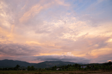 Wall Mural - The white clouds have a strange shape and moutain. The sky and the open space have mountains below. Clouds floating above the mountains.