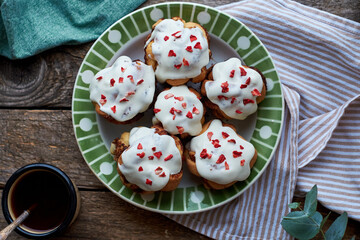 Sticker - Cinnamon rolls with cream and freeze-dried strawberries, round yeast rolls. Top view, wooden background.