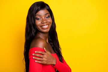 Sticker - Photo of charming sweet dark skin girl dressed red top hugging herself empty space isolated yellow color background