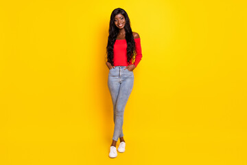 Poster - Full length body size view of charming slender cheerful wavy-haired girl posing isolated over bright yellow color background