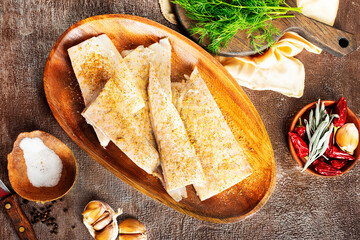 Canvas Print - Fish fillet on a woodentray. white fish prepare for cooking