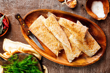 Wall Mural - Fish fillet on a woodentray. white fish prepare for cooking